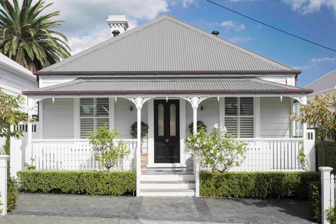 White New Zealand villa with veranda and picket fence