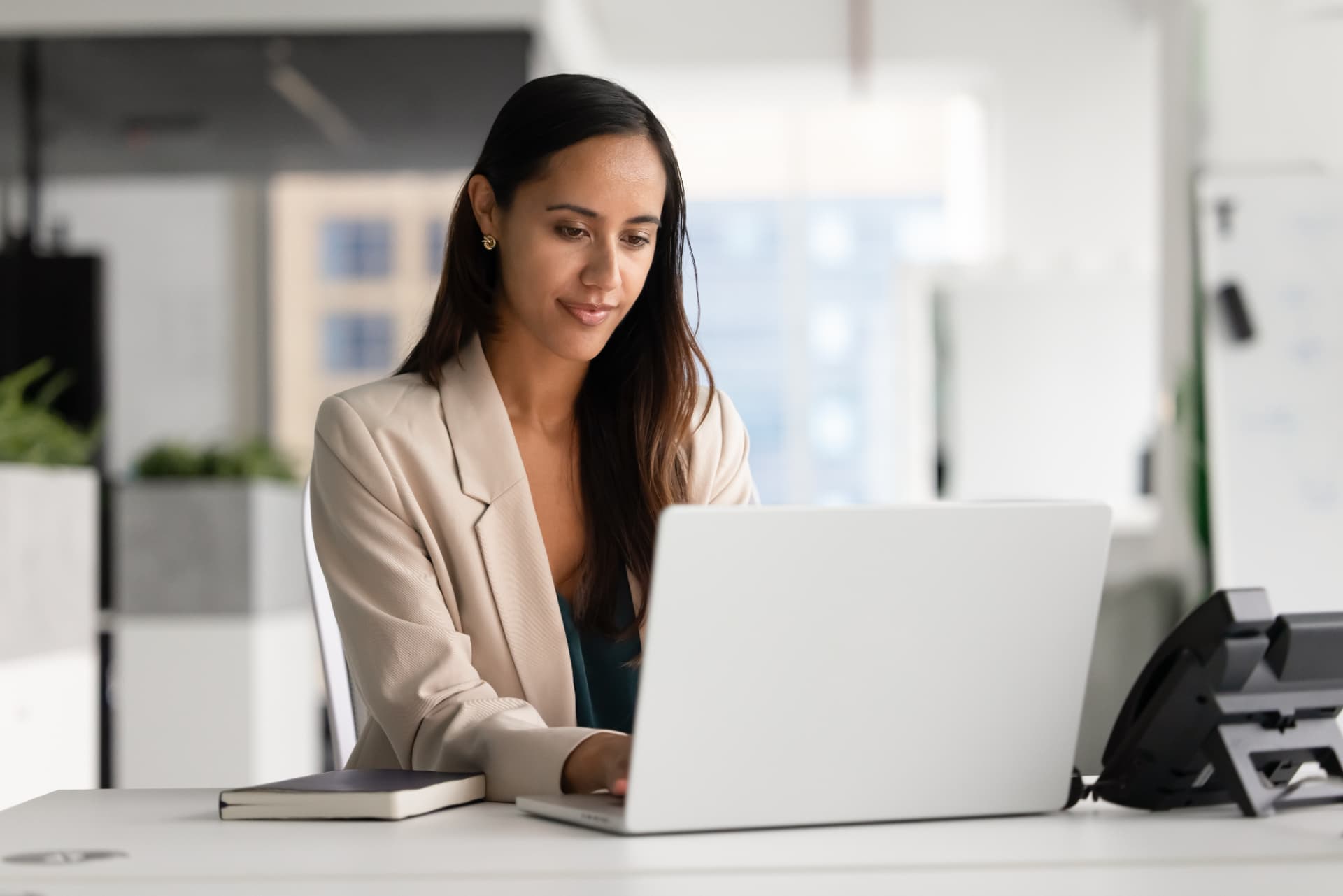 Real estate administrator working at a laptop