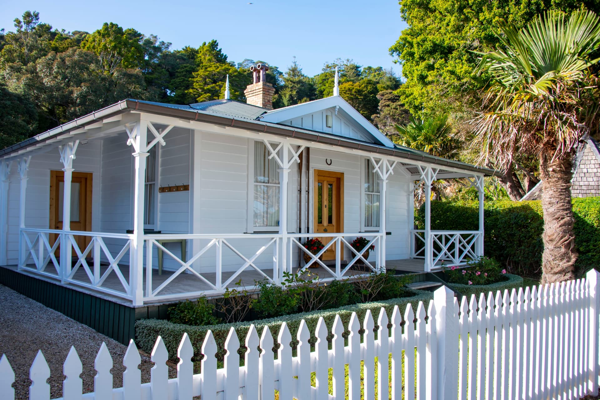 New Zealand villa with veranda, lawn, and picket fence